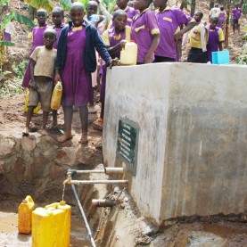 Pupils collecting water in Uganda. In every society, water , health and education are closely inter-related