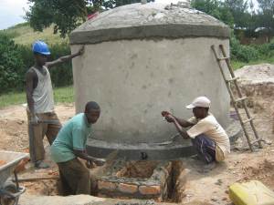 Men constructing a water tank in Uganda for rainwater harvesting 